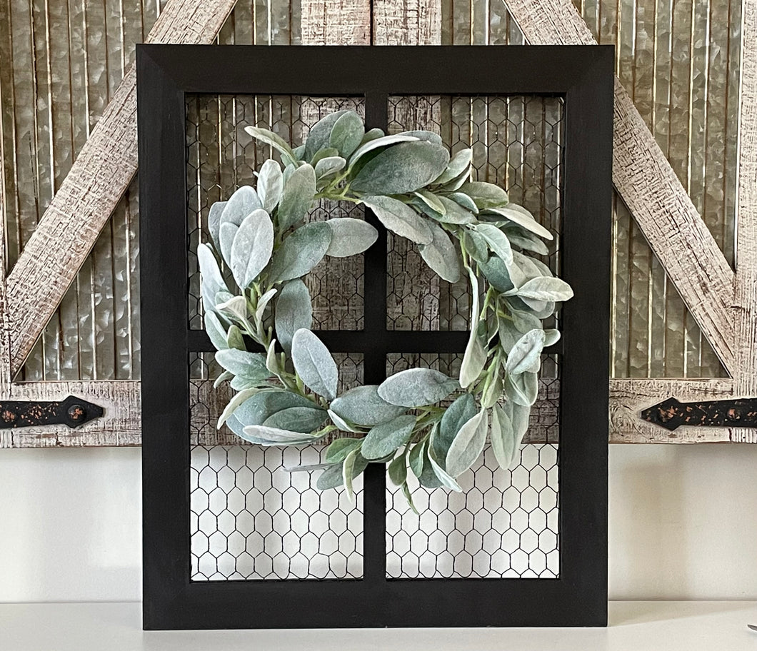 Rustic farmhouse wall decor including wreath