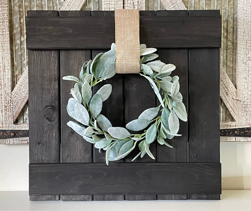 Rustic farmhouse wall decor including wreath